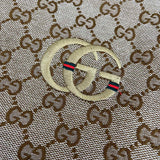 Close-up detail shot of Gucci luxury clothing with monogram-inspired silhouette