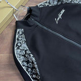 Close-up detail shot of Louis Vuitton luxury clothing with label-forward styling