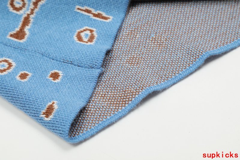 Side profile of Rhude luxury clothing with label-forward styling