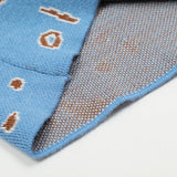 Side profile of Rhude luxury clothing with label-forward styling