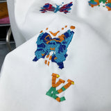Flat lay presentation of Louis Vuitton luxury clothing with label-forward styling
