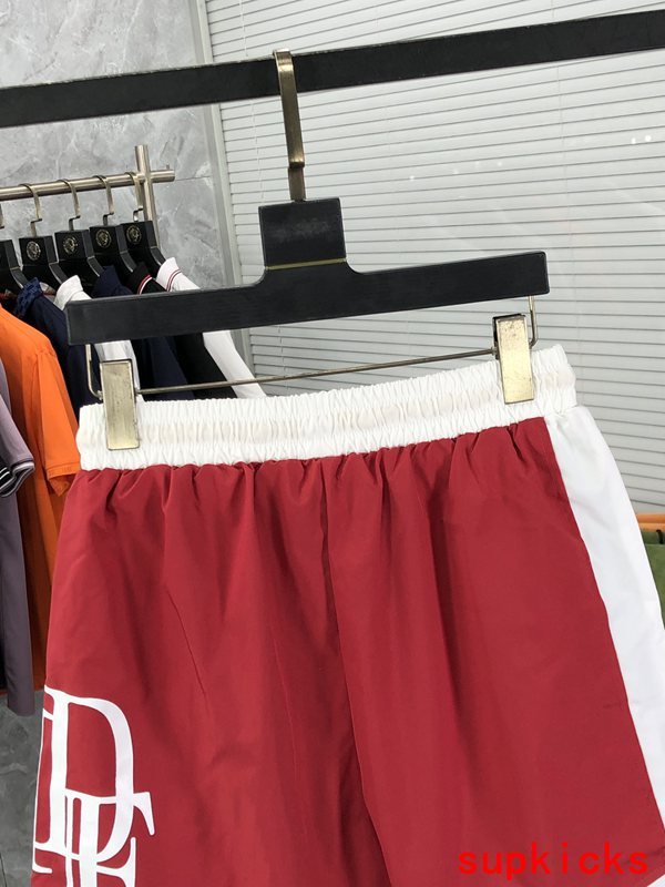Flat lay presentation of Rhude luxury clothing with label-forward styling