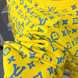 Flat lay presentation of Louis Vuitton luxury clothing with everyday silhouette
