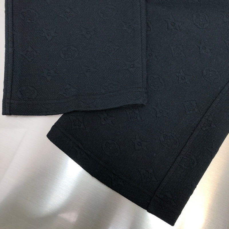 Flat lay presentation of Louis Vuitton luxury clothing with signature branding