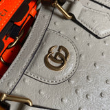 Styled lifestyle shot of classic signature women's handbag – women's luxury handbag