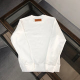 Close-up detail shot of Louis Vuitton luxury clothing with signature branding