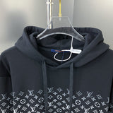 Close-up detail shot of Louis Vuitton luxury clothing with monogram-inspired silhouette