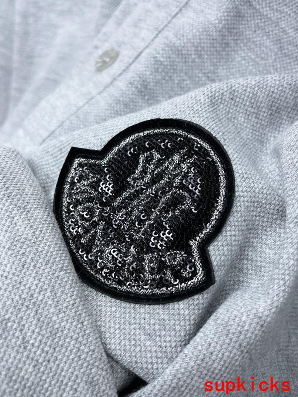 Flat lay presentation of Moncler luxury clothing with logo-detail design