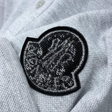 Flat lay presentation of Moncler luxury clothing with logo-detail design