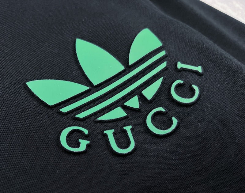 Flat lay presentation of Gucci luxury clothing with signature branding