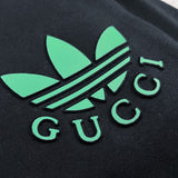 Flat lay presentation of Gucci luxury clothing with signature branding
