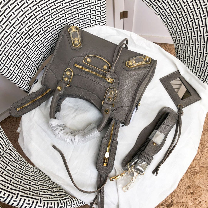 Handle and strap detail of polished structured women's handbag – women's designer-style accessory