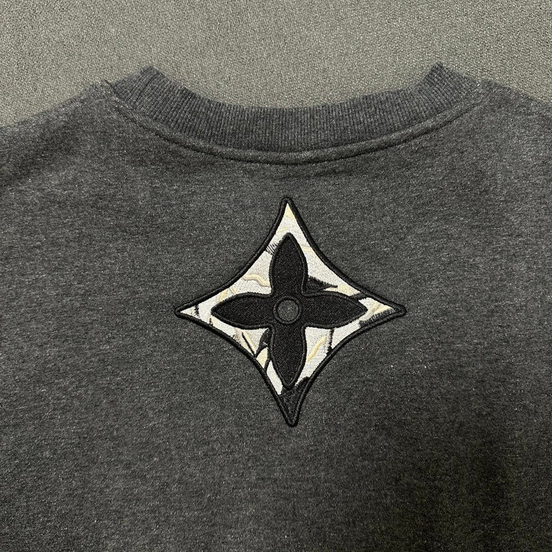 Side profile of Louis Vuitton luxury clothing with logo-detail design