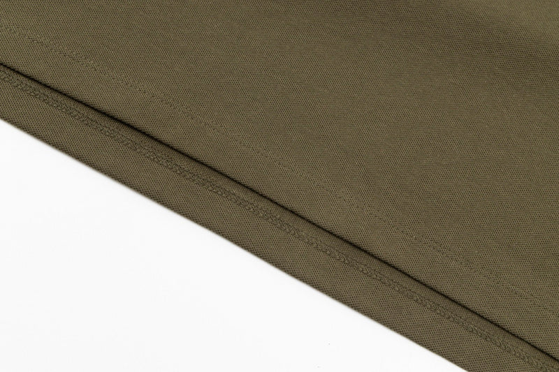 Flat lay presentation of Polo cotton polo shirt with monogram-inspired silhouette