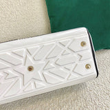 Styled lifestyle shot of modern polished women's handbag – women's luxury handbag
