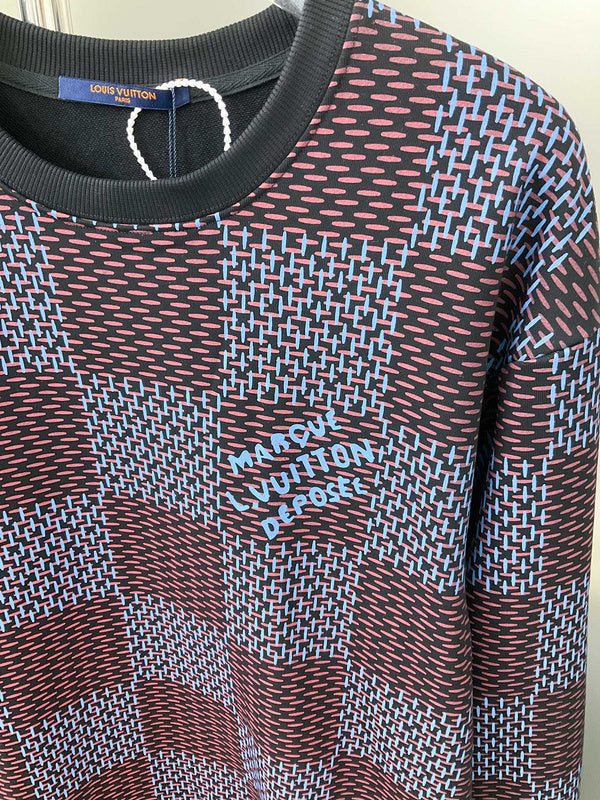 Flat lay presentation of Louis Vuitton luxury clothing with label-forward styling