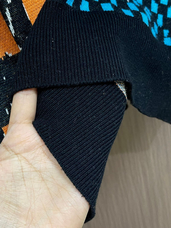 Close-up detail shot of Louis Vuitton luxury clothing with logo-detail design