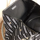 Styled lifestyle shot of refined signature women's handbag – women's premium purse