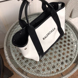 Handle and strap detail of everyday-luxe statement women's handbag – women's luxury accessory