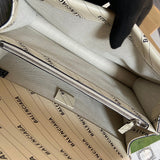 Side profile of statement modern women's handbag – women's luxury accessory