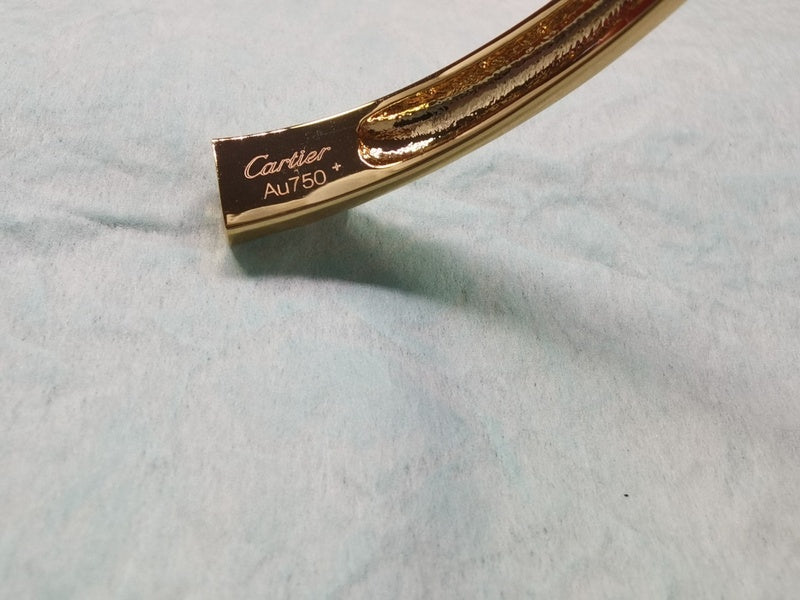 Side view of Cartier unisex jewelry piece