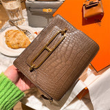  sleek top-handle bag styled with outfit