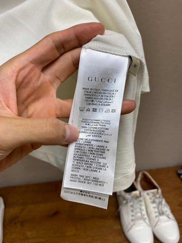 Close-up detail shot of Gucci luxury clothing with signature branding