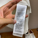 Close-up detail shot of Gucci luxury clothing with signature branding