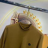Close-up detail shot of Louis Vuitton luxury clothing with monogram-inspired silhouette