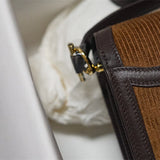 Side view of polished structured handbag