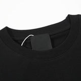 Close-up detail shot of Givenchy luxury clothing with monogram-inspired silhouette