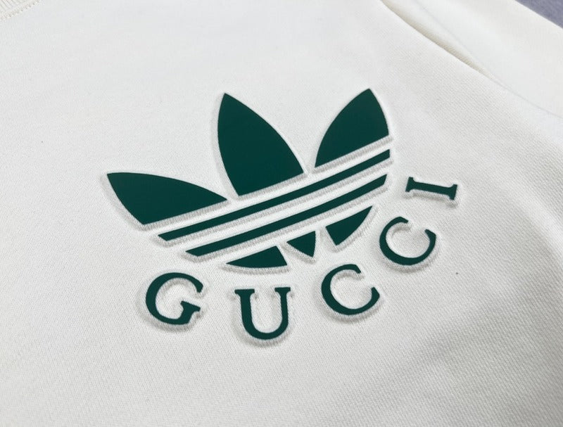 Flat lay presentation of Gucci luxury clothing with signature branding