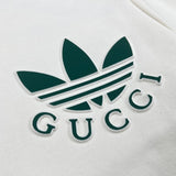 Flat lay presentation of Gucci luxury clothing with signature branding