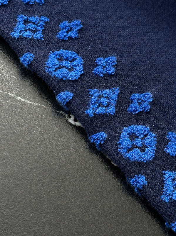 Flat lay presentation of Louis Vuitton luxury clothing with contemporary cut