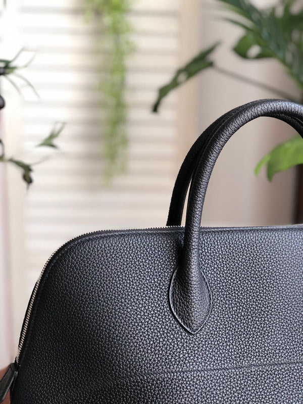 Side view of sleek structured handbag