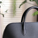 Side view of sleek structured handbag