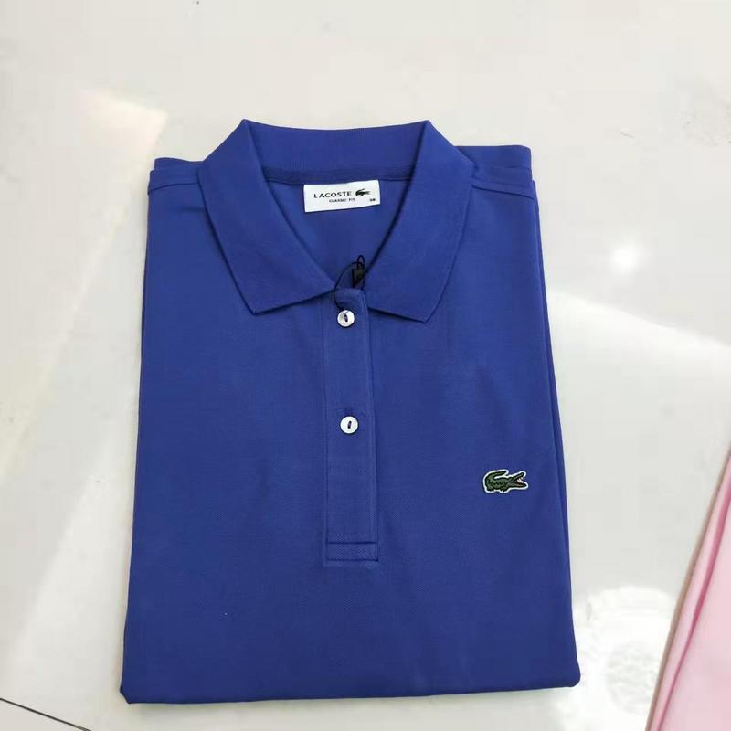 Flat lay presentation of Lacoste luxury clothing with signature branding