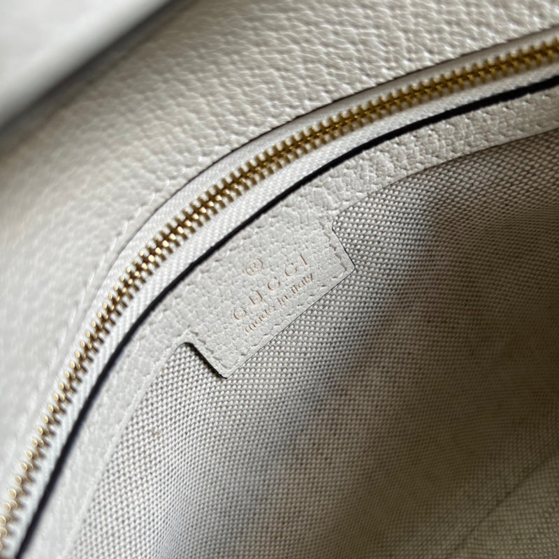 Side profile of chic polished women's handbag – women's statement bag