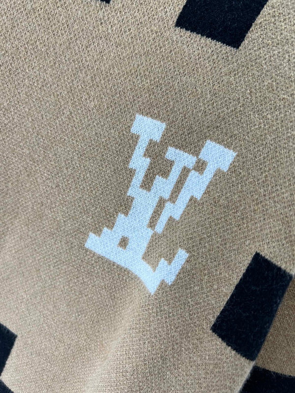 Flat lay presentation of Louis Vuitton luxury clothing with logo-detail design