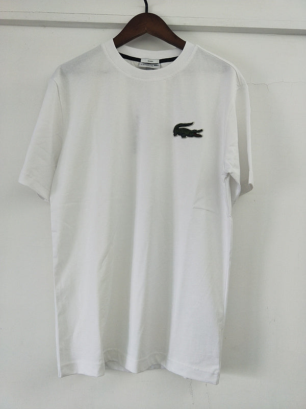Flat lay presentation of Lacoste luxury clothing with signature branding