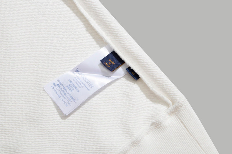 Side profile of Louis Vuitton luxury clothing with signature branding