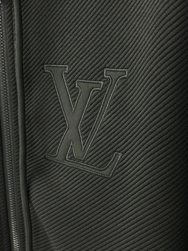 Flat lay presentation of Louis Vuitton luxury clothing with label-forward styling