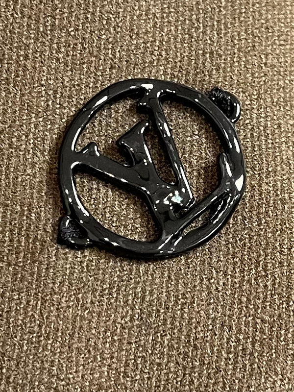 Close-up detail shot of Louis Vuitton luxury clothing with signature branding