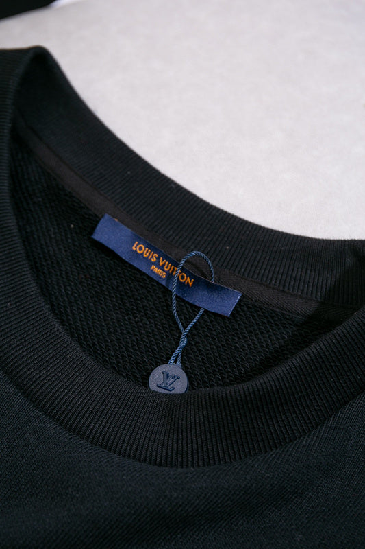 Front view of Louis Vuitton luxury clothing with label-forward styling