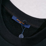 Front view of Louis Vuitton luxury clothing with label-forward styling