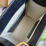 Side profile of sleek signature women's handbag – women's luxury handbag