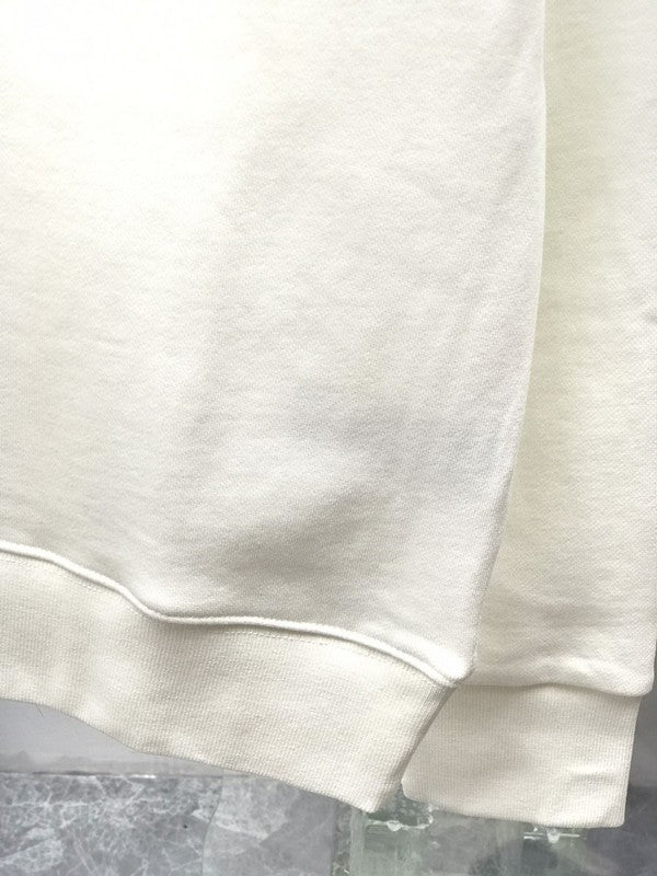 Close-up detail shot of Louis Vuitton luxury clothing with label-forward styling