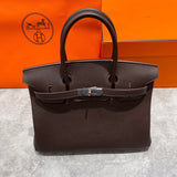 Side view of tailored structured handbag