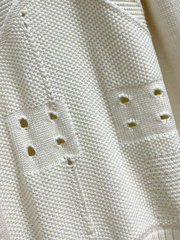 Flat lay presentation of Louis Vuitton luxury clothing with monogram-inspired silhouette