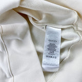 Close-up detail shot of Gucci luxury clothing with signature branding